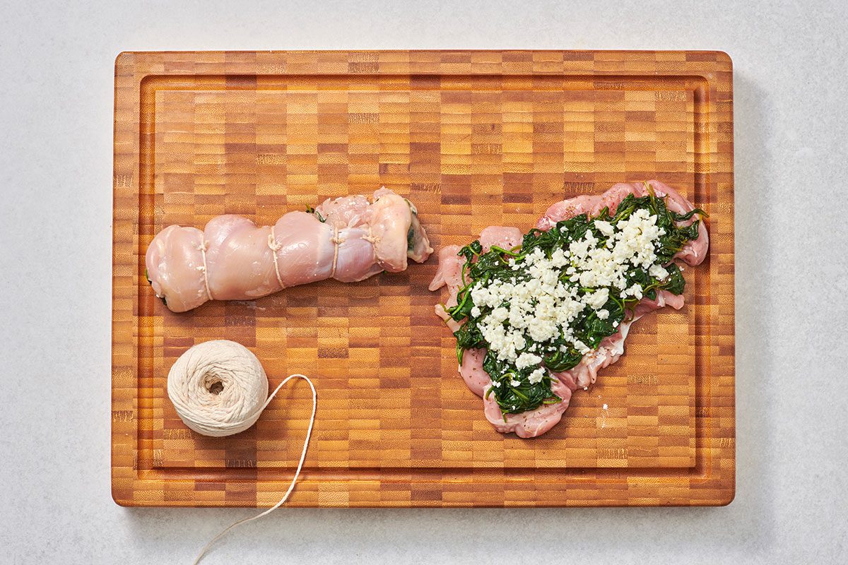 Prepping and stuffing the chicken thighs on a cutting board