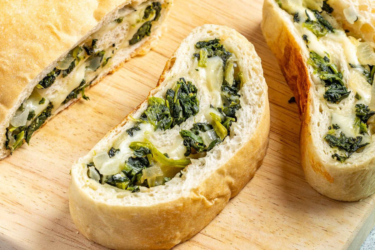 Taste of Home Spinach Bread photo of the finished recipe sliced and served on plates.