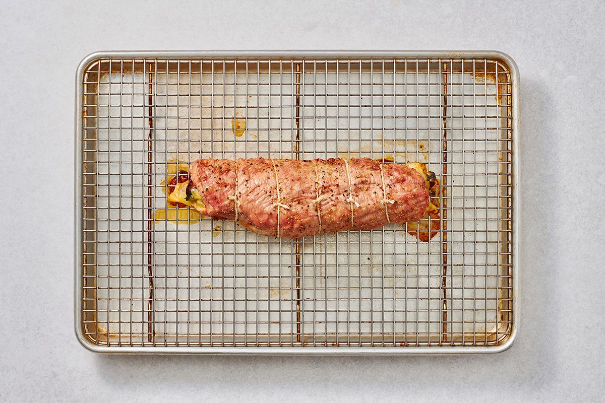 Cooked pork tenderloin on a baking sheet