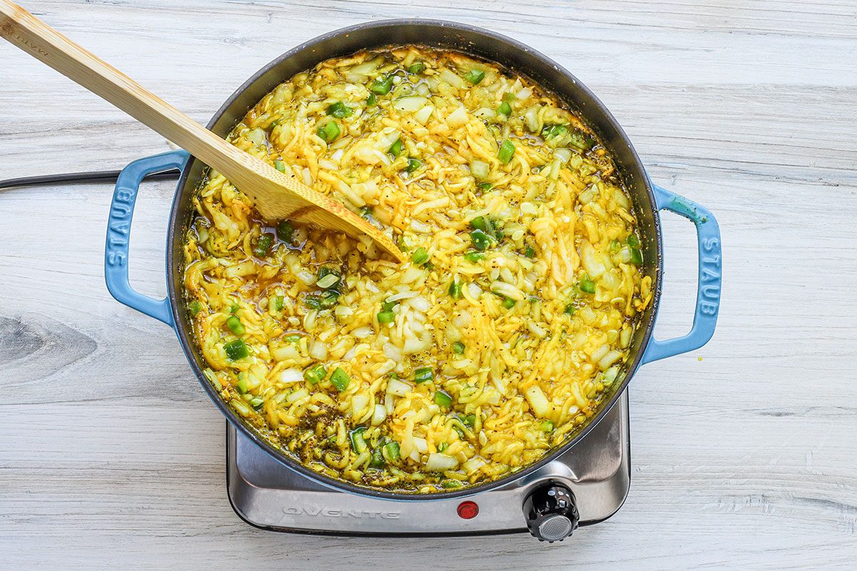 Simmering the squash relish mixture in a Dutch oven.