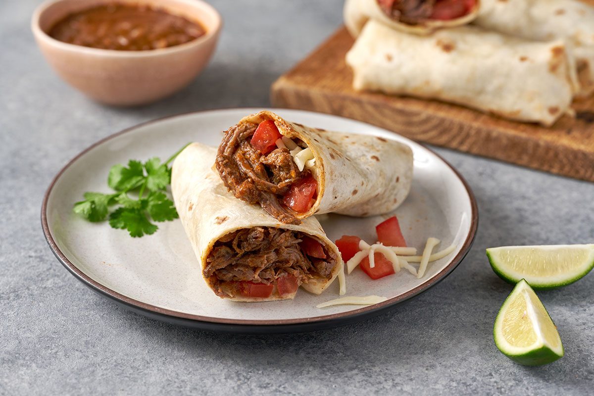 A close-up shot of the Shredded Steak Burritos, highlighting the shredded beef filling and melted cheese for a mouth-watering view