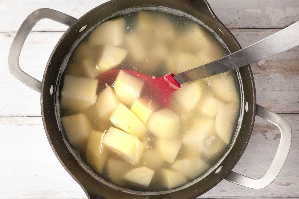 Step 1 of Taste of Home Stewed Potatoes is to add the diced potatoes and fill the pot with just enough cold water to cover entirely. Place covered on the stovetop over medium heat and bring it to a simmer.