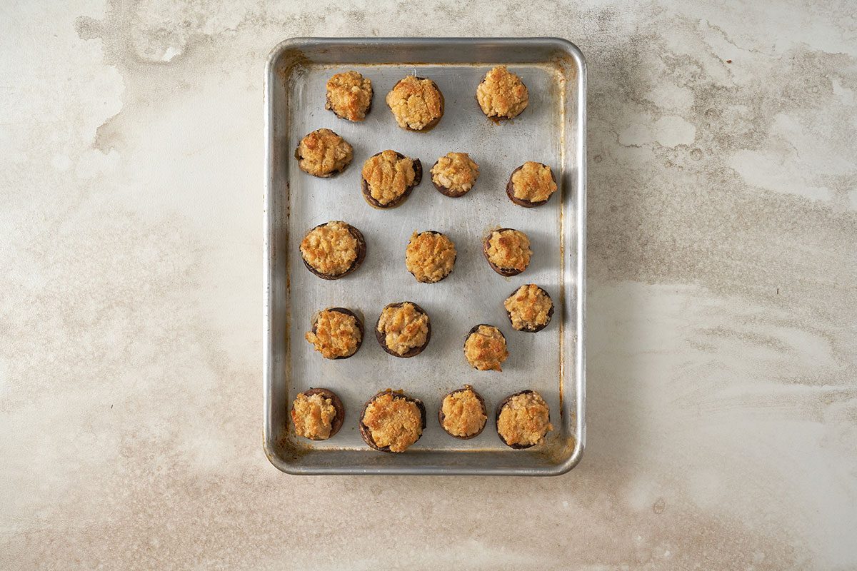 Baking the mushrooms stuffed with crabmeat at 400°F until tender, for the Stuffed Mushrooms with Crabmeat recipe, by Taste of Home.
