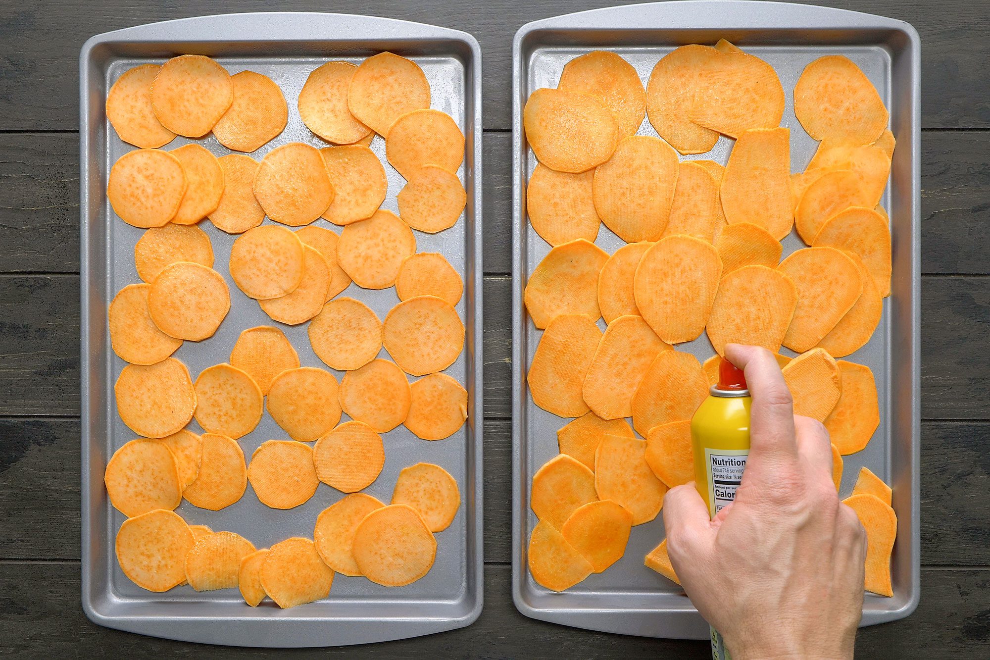 Two baking sheets filled with sliced sweet potatoes