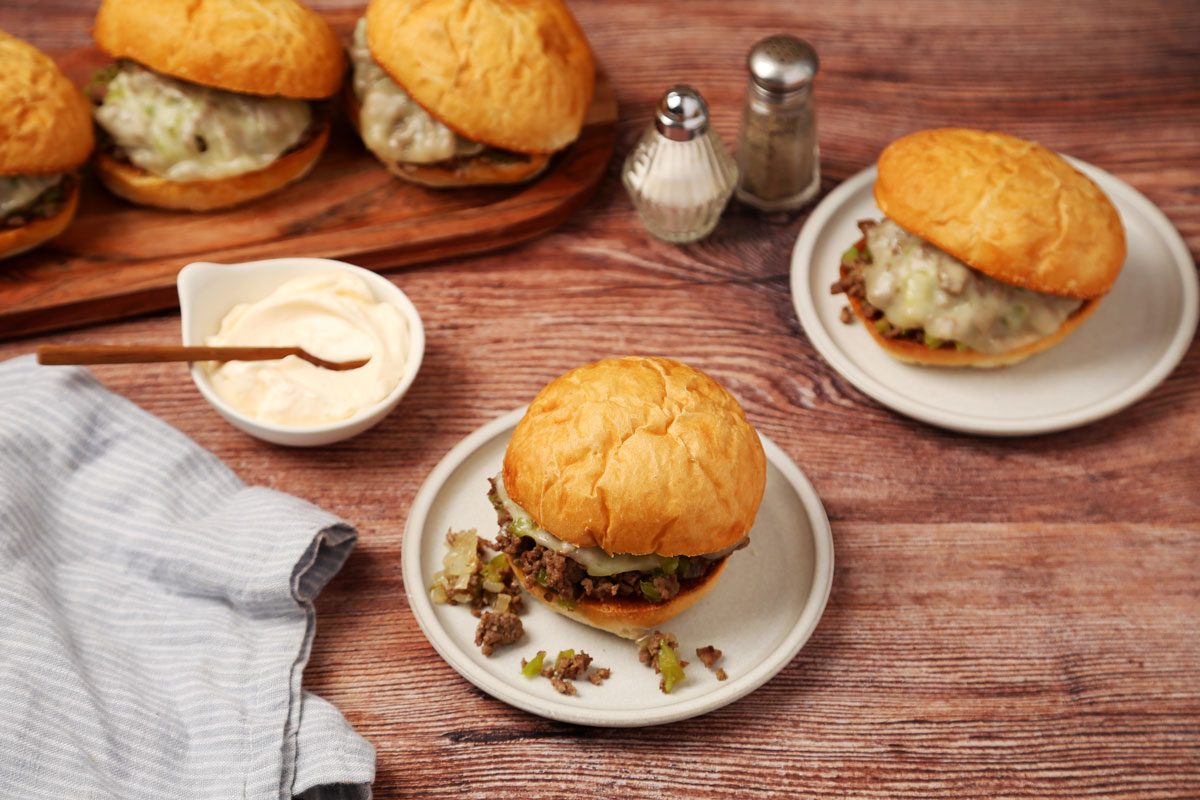 Close up of Taste of Home's Philly Cheesesteak Sloppy Joes on a wooden surface.