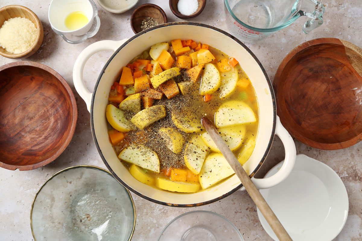 Process of making Taste of Home's butternut squash and sweet potato soup laid out on a brown marble surface.