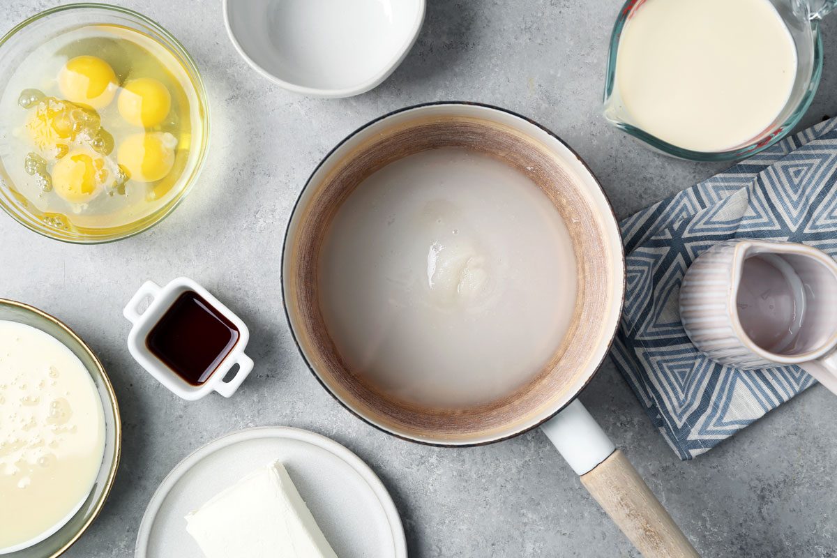 Process of making Taste of Home's Flan de Queso. Making homemade caramel for the flan in a saucepan.