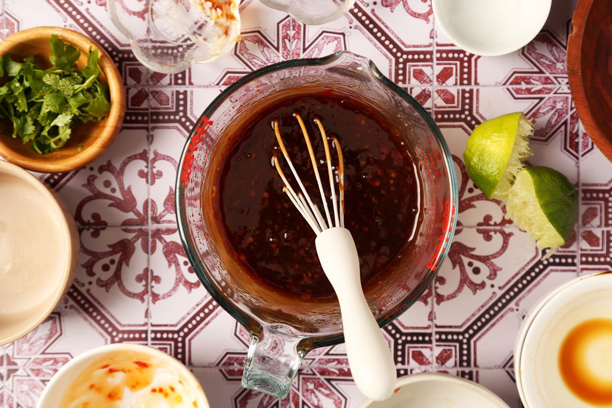 Process of making Taste of Home's Pork Bowl in a pressure cooker on a red and white tiled surface.