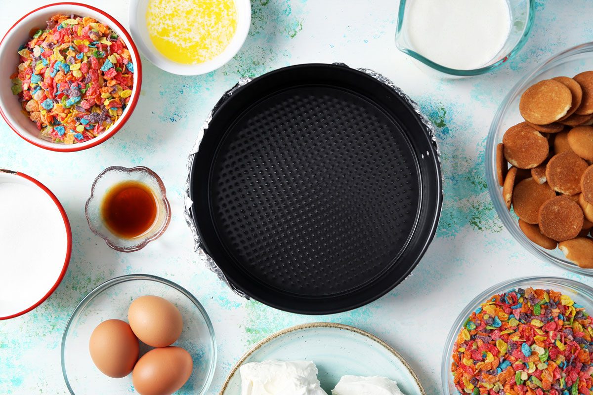 Process of making Taste of Home's Fruity Pebbles Cheesecake. Springform pan wrapped in foil.