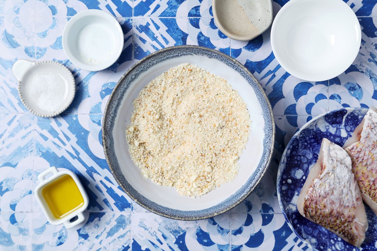 Process of making Taste of Home's Pan-Seared Red Snapper laid seared in a pan on a blue and white tiled background.