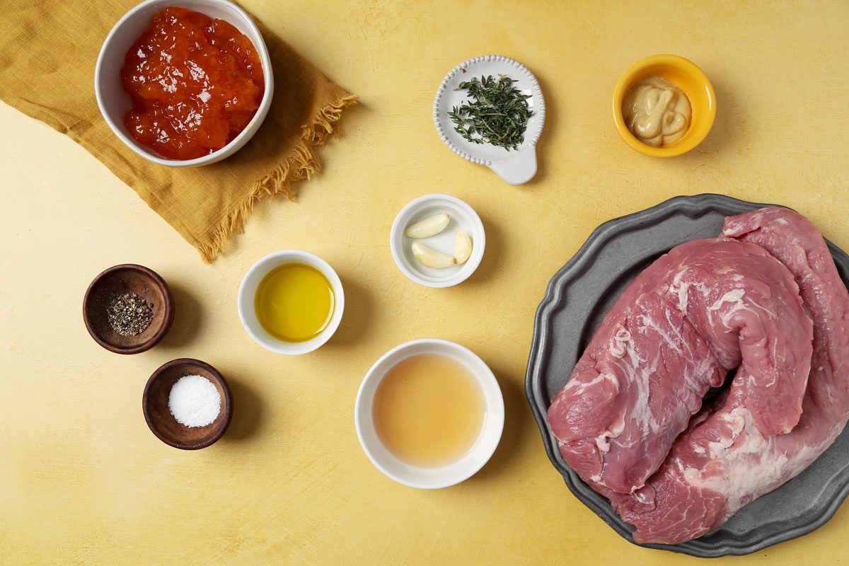 Ingredients for Taste of Home's apricot glazed pork tenderloin laid out in small bowls on a yellow surface.