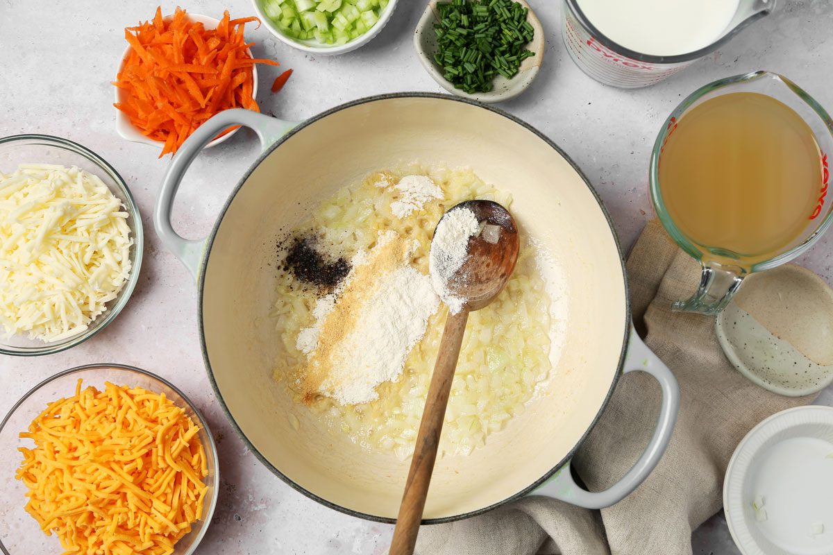 Process of making Taste of Home's Cheddar Cheese Soup in a pot on a grey surface.
