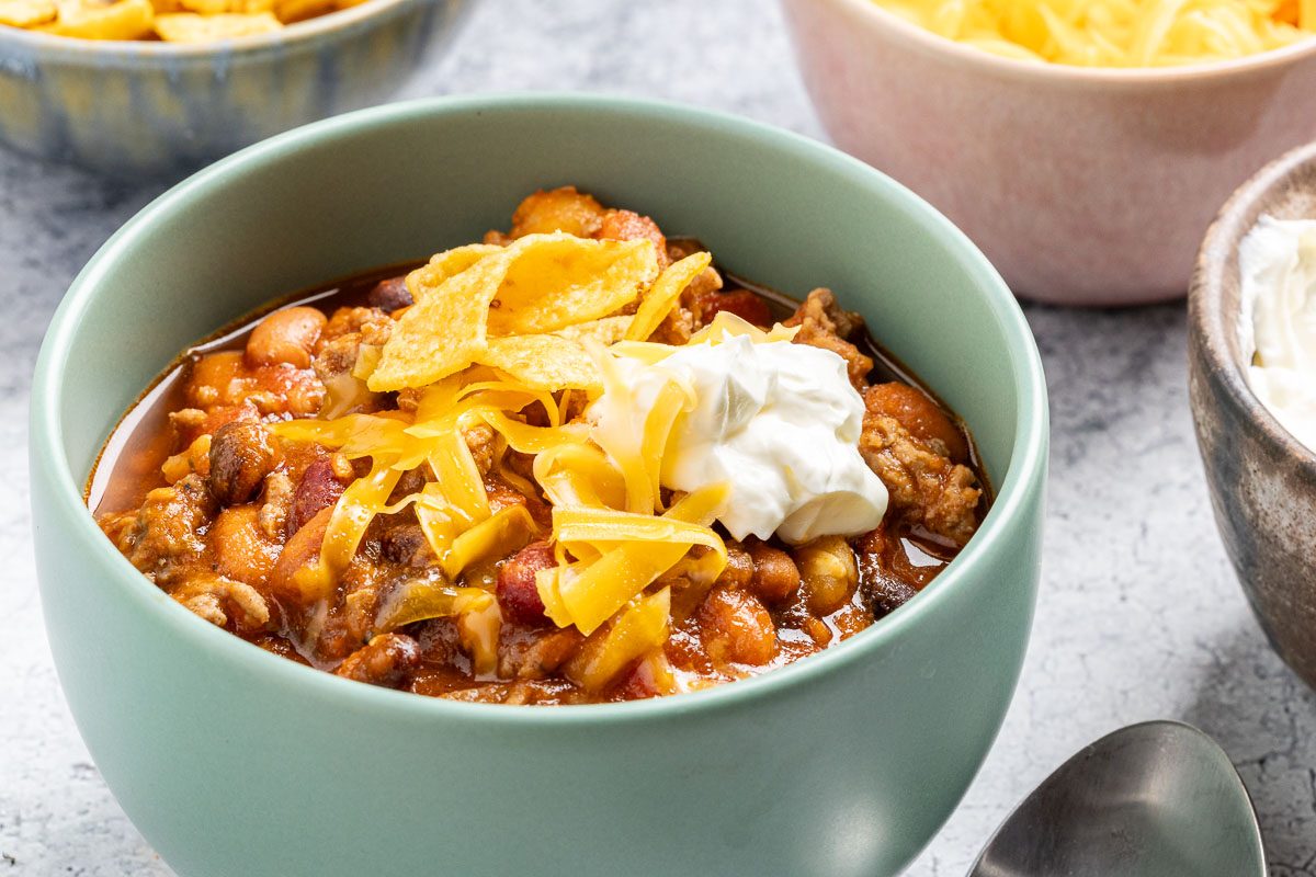 Taco Chili served in a bowl with cheese and sour cream