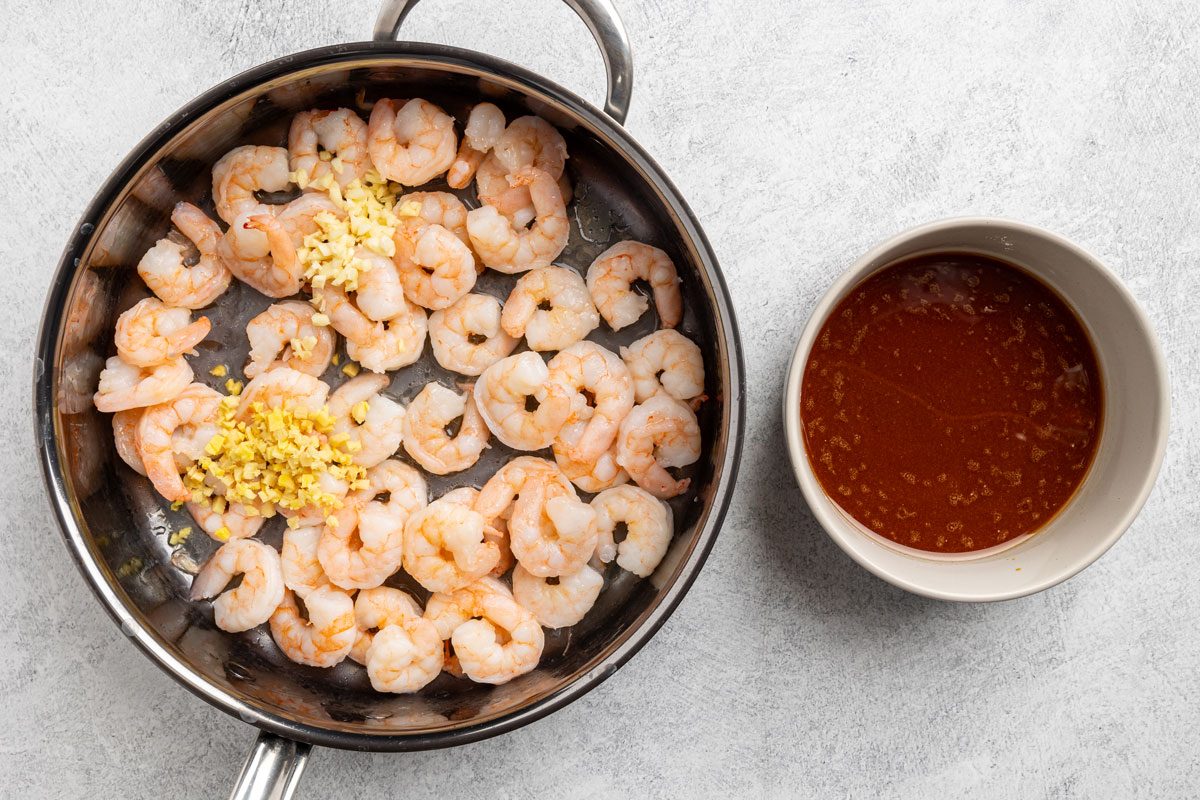 adding the ginger, garlic, and teriyaki sauce to the skillet.