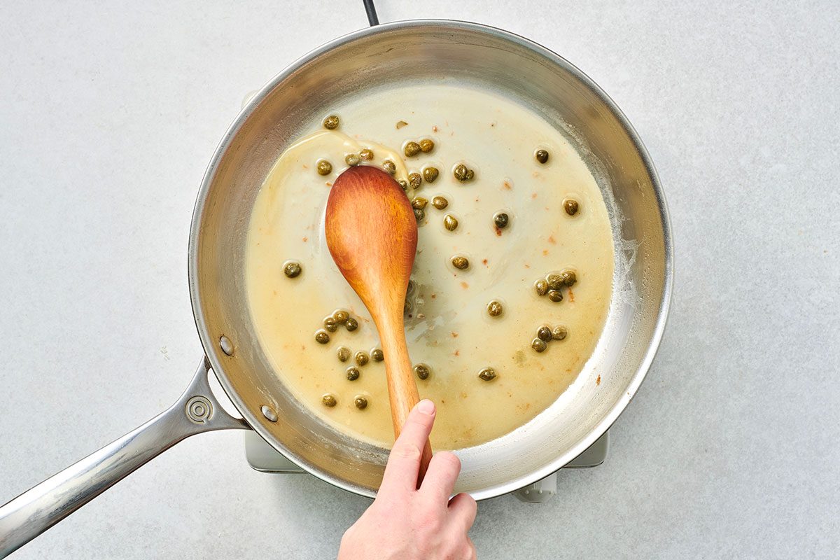 Lemon butter caper sauce in a skillet