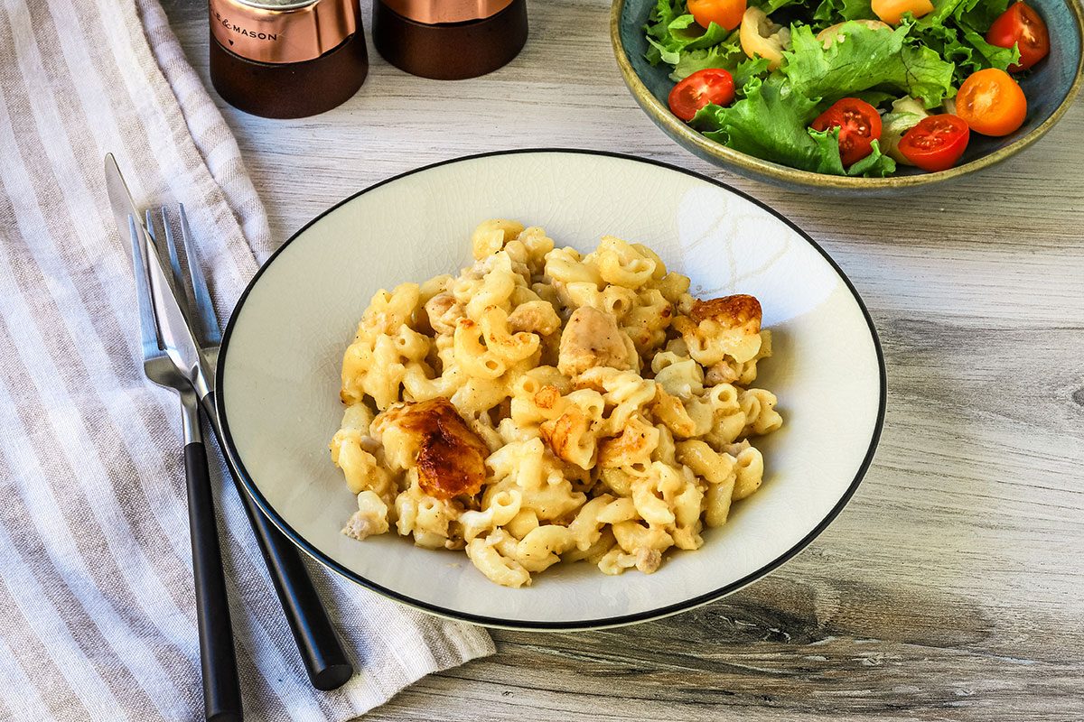 A serving of tuna mac and cheese with a salad alongside, from a recipe by Taste of Home.