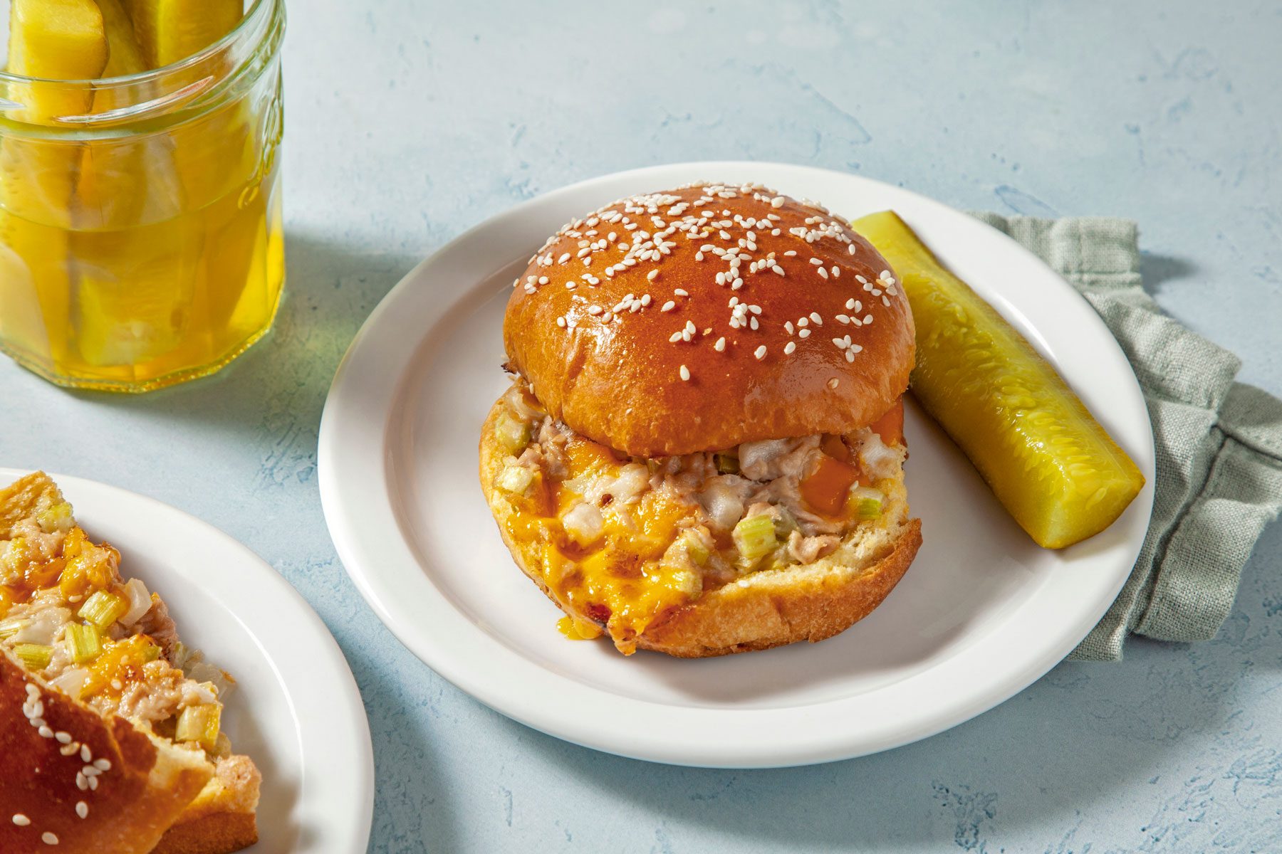 Tuna Melt sandwich served with a pickle.