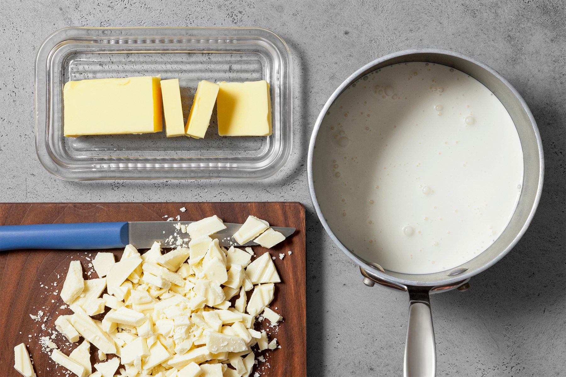 Overhead shot of all ingredients; wooden board; grey surface;