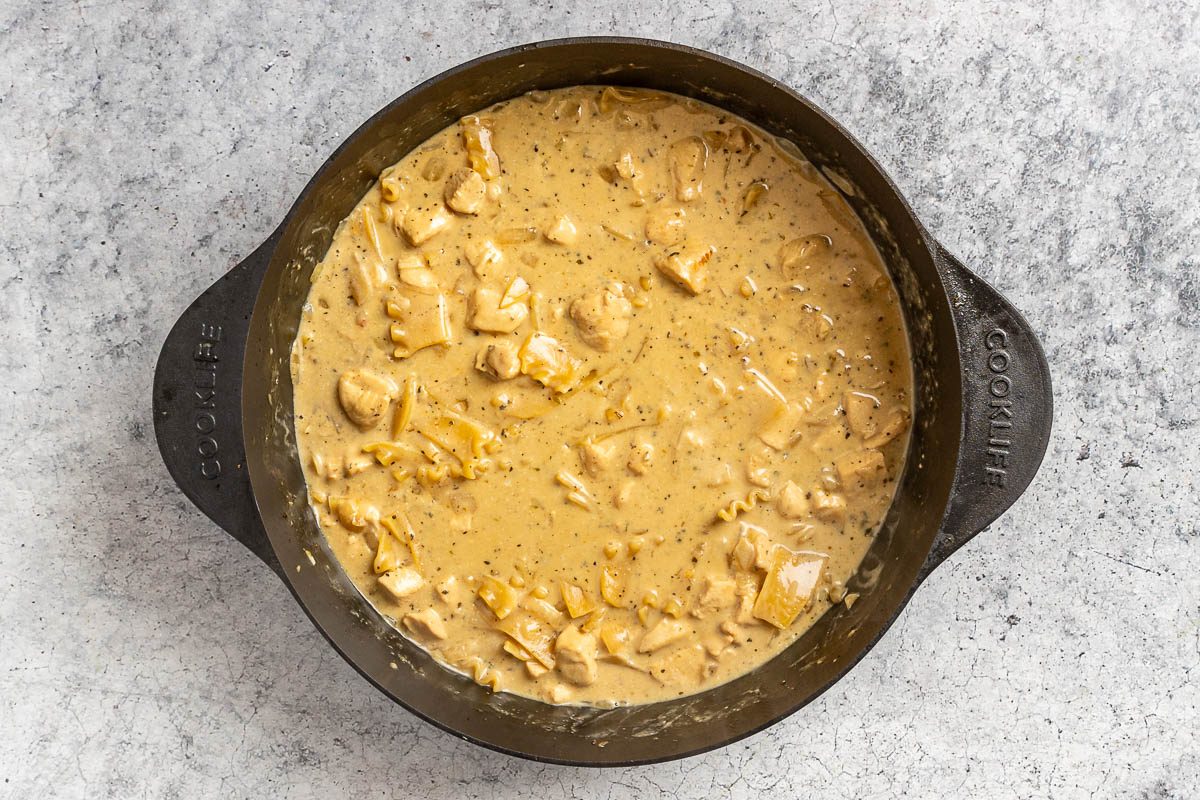 Taste of Home White Lasagna Soup photo of adding the cream and noodles.