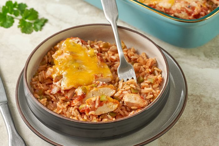 Overhead view of the fully cooked and cheesy Taste of Home Arroz con Pollo, ready to serve, with golden melted cheese and tender chicken over the rice.