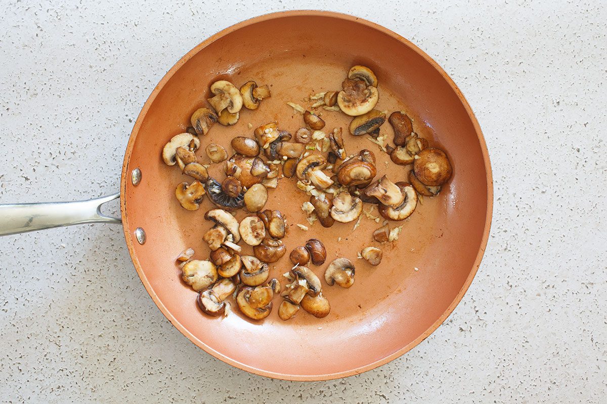 Mushrooms and garlic cooking in skillet 