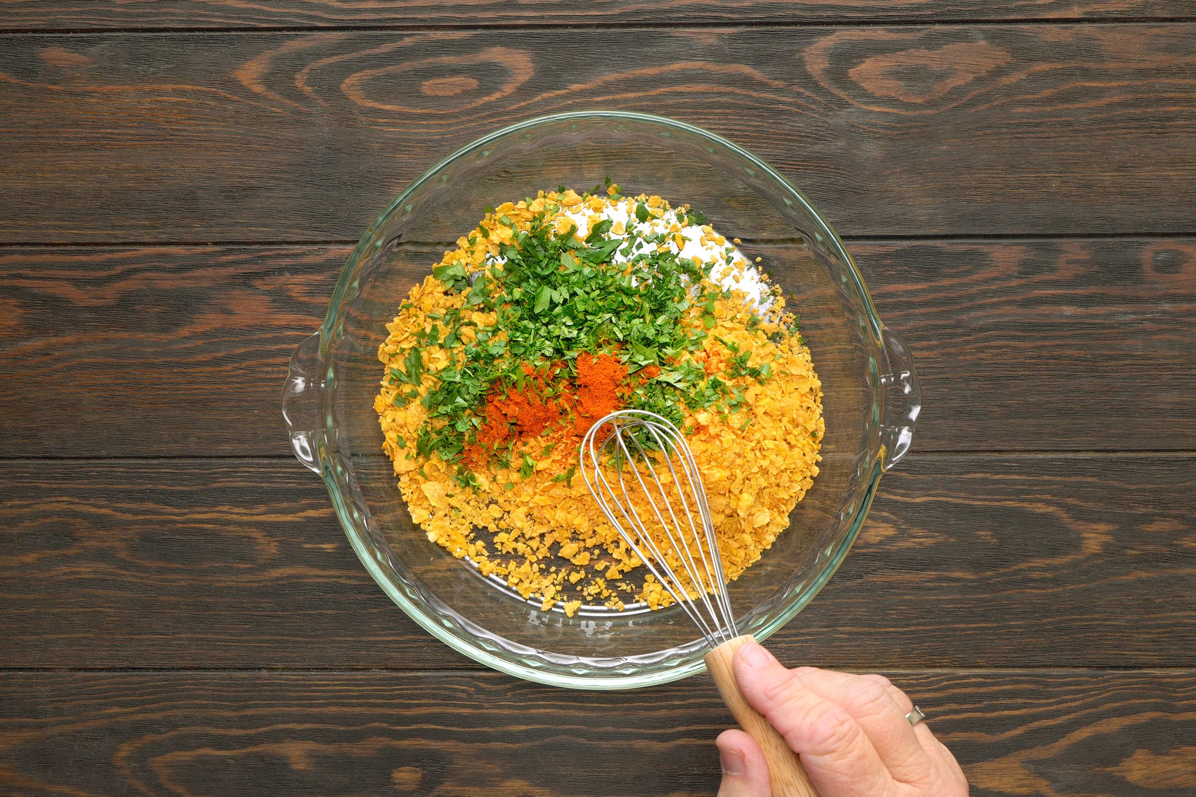 Cornflakes, parley and paprika combined in a small bowl