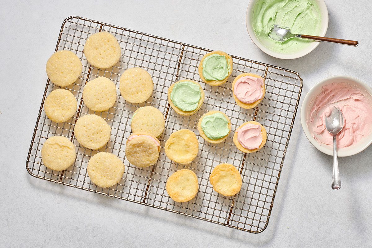 Forming wafer cookies by spreading filling on the bottom of half of the cookies, then topping with the remaining cookies