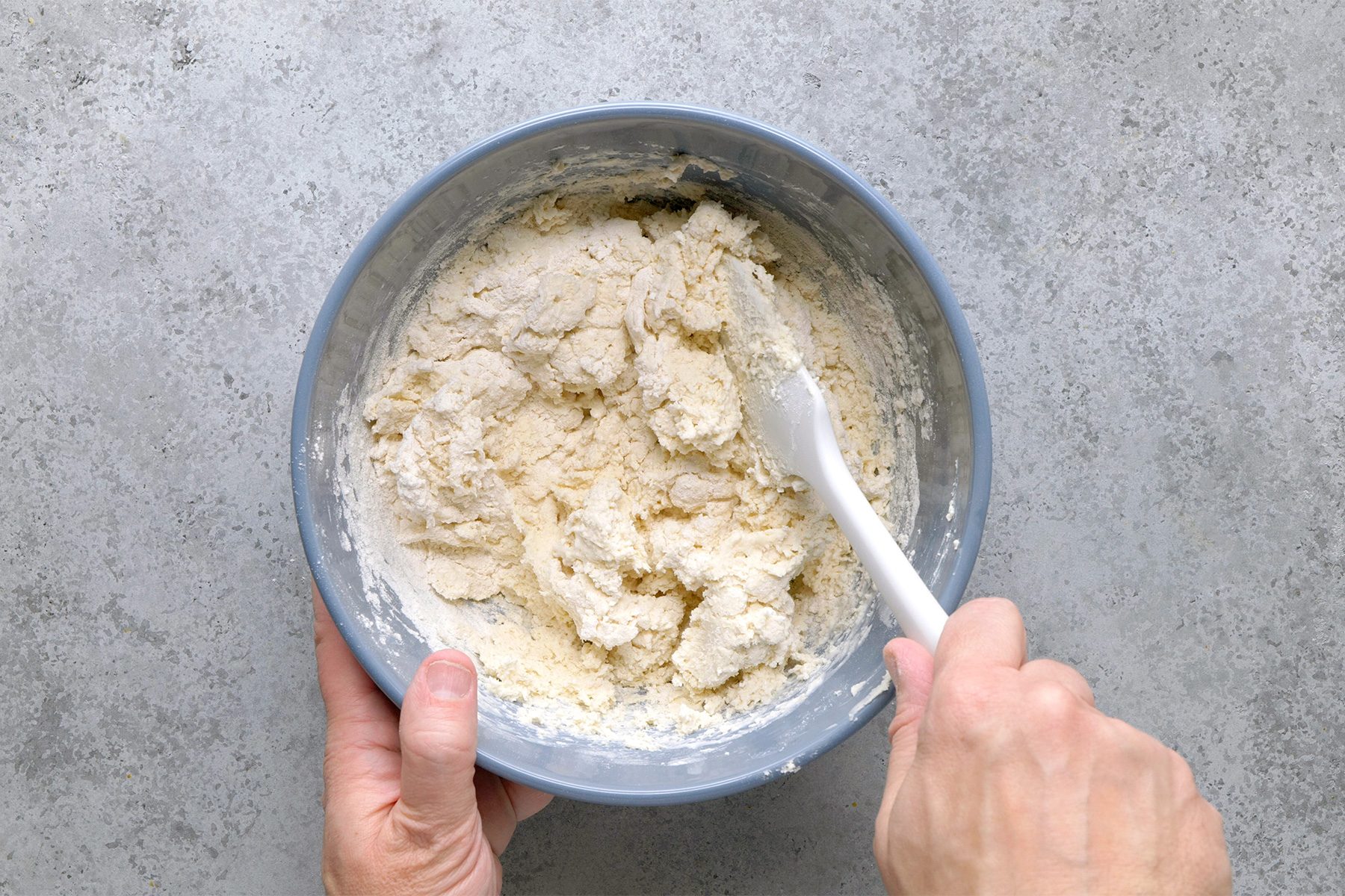 Overhead shot of add cream; stir just until moistened; spatual; grey surface;