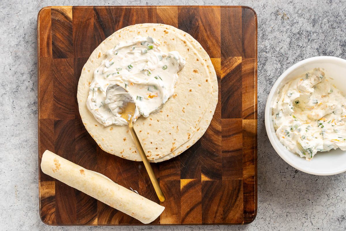 Taste of Home Easy Pinwheel Recipe photo of making the filling and rolling up the tortillas.