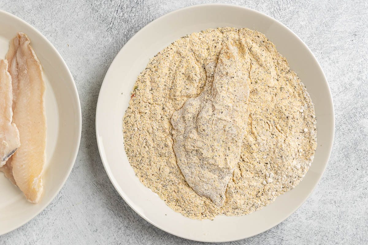 Taste of Home Grilled Catfish photo of dredging the fish in the coating.