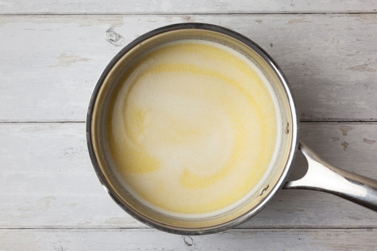 Step 2 of Taste of Home Hawaiian Sweet Bread is to heat the butter, milk and juice