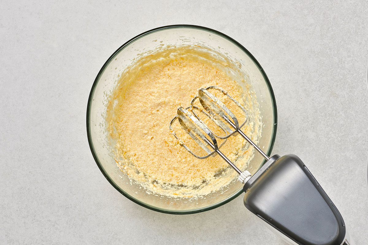 Almond extract, eggs, orange juice, and orange peel added to the creamed butter and sugar mixture.