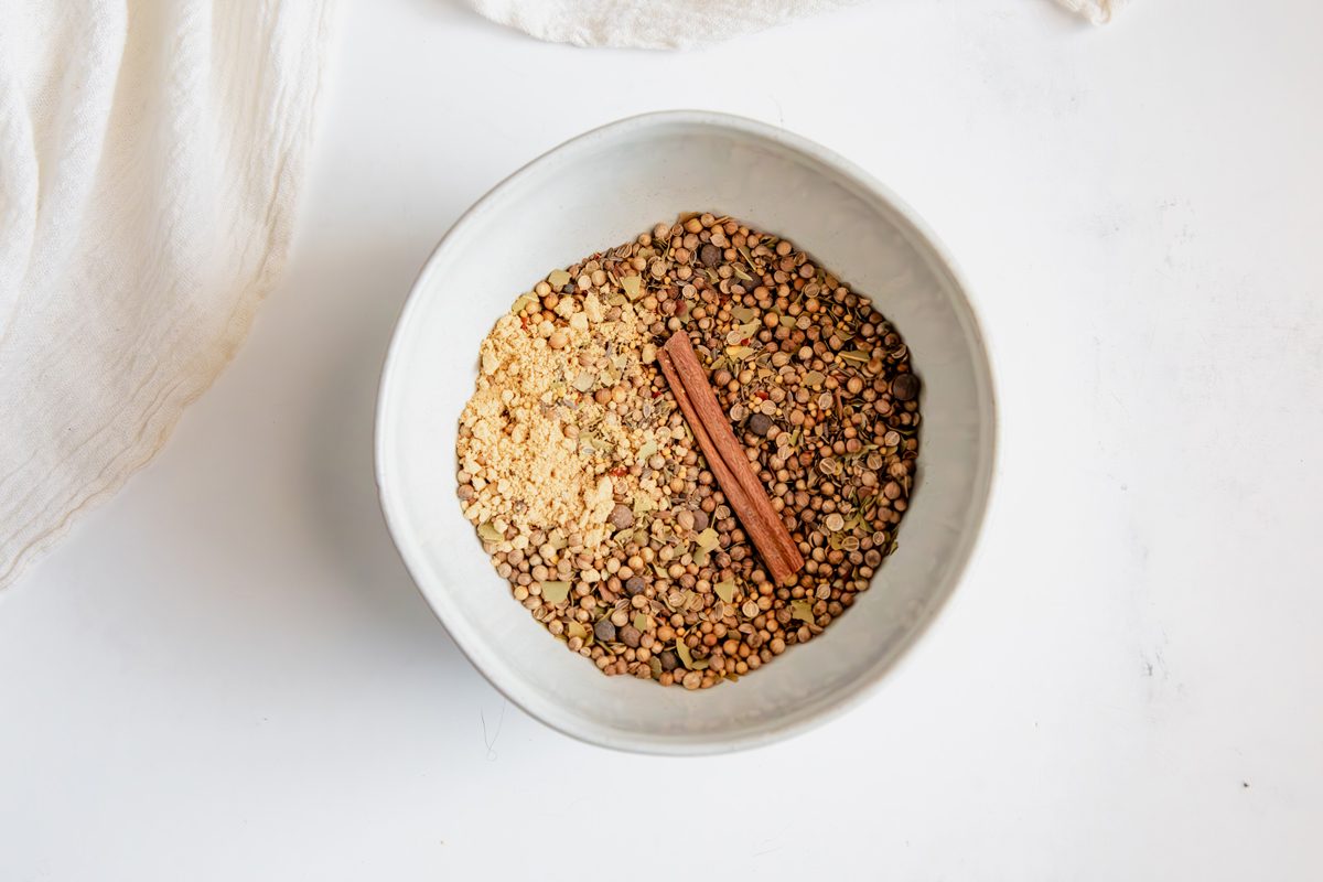Overhead shot for Taste of Home Pickling Spice with all ingredients in bowl mixed.