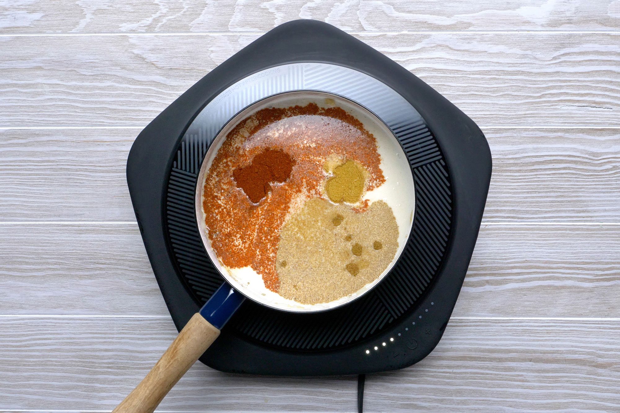 Stir in the water, cream, chili powder, bouillon, cumin and coriander in a small saucepan