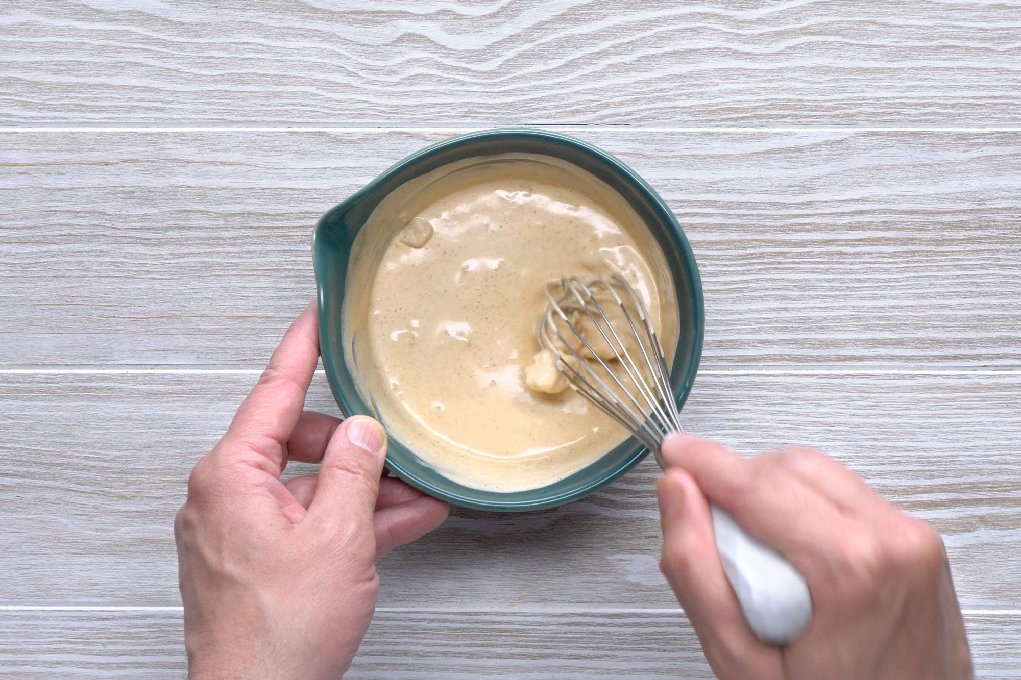 Gradually stir 1/2 cup hot soup into sour cream in a small bowl