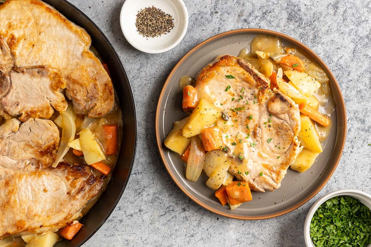 Taste of Home Skillet Pork Chops photo of all the ingredients cooked in the skillet and one plated porkchop.
