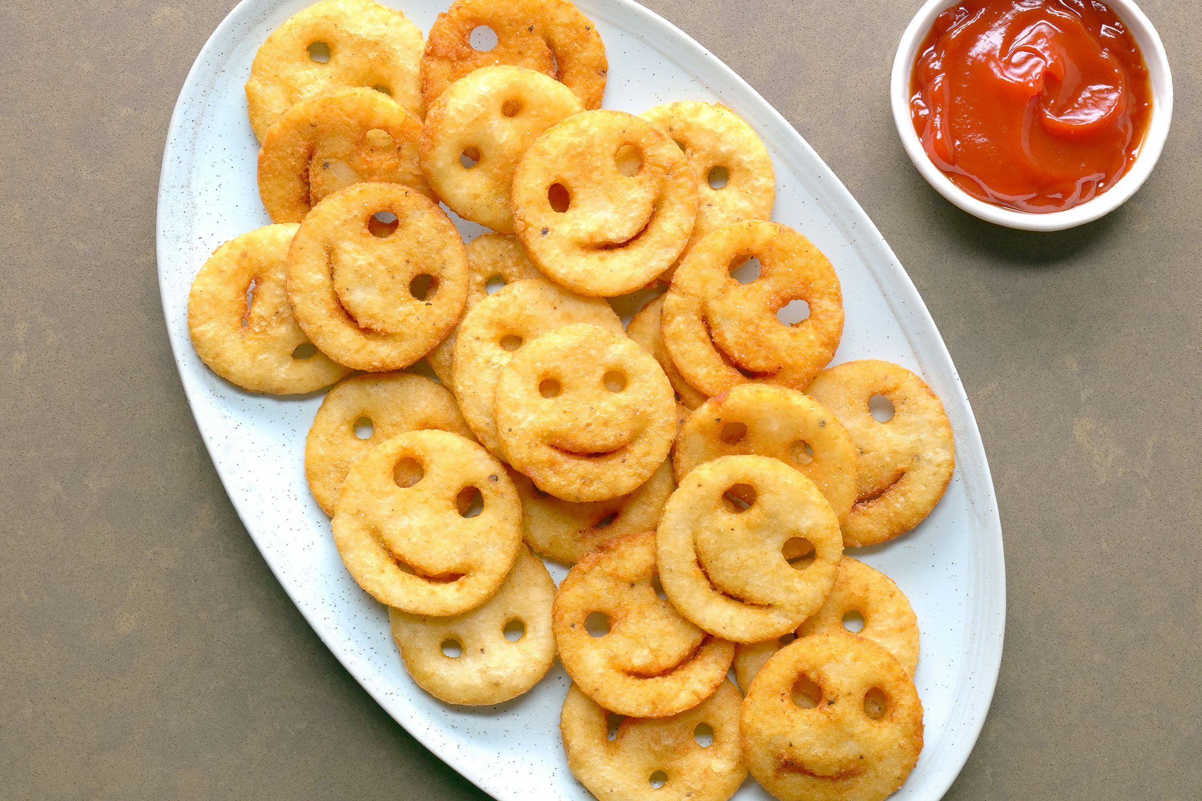 Smiley Fries on a plate with tomato ketchup on side