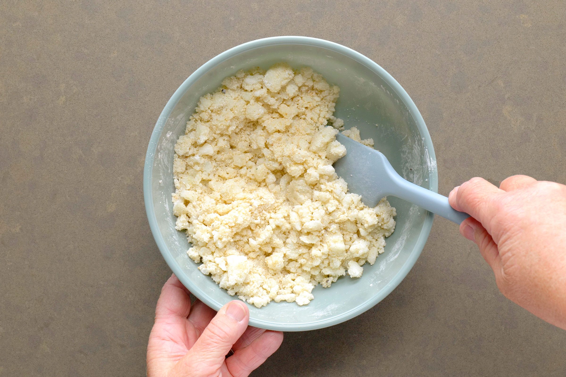 Potatoes, breadcrumbs, cornstarch and seasonings mixed together in a bowl