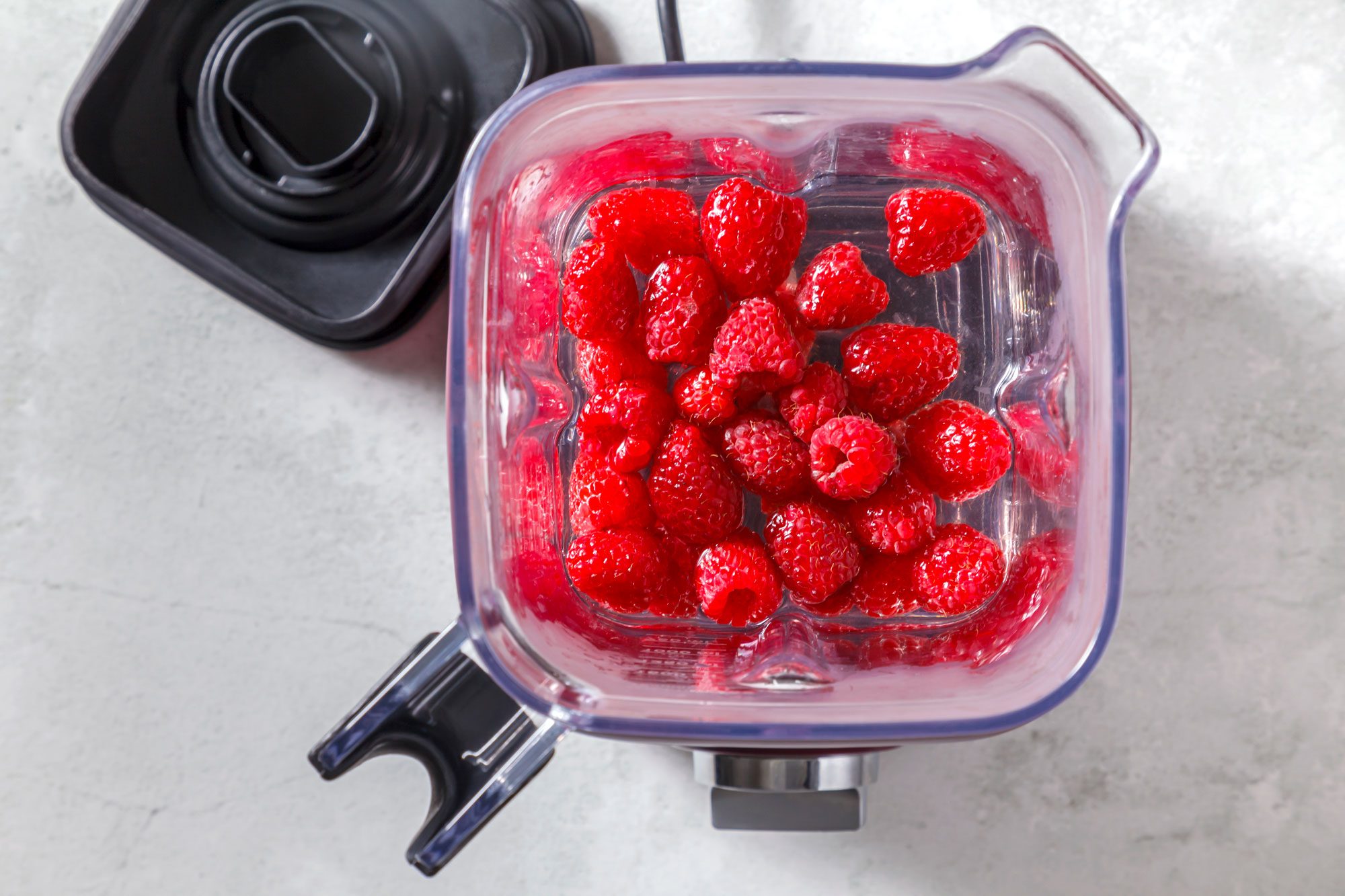 place raspberries; sugar water and lemon juice in a blender