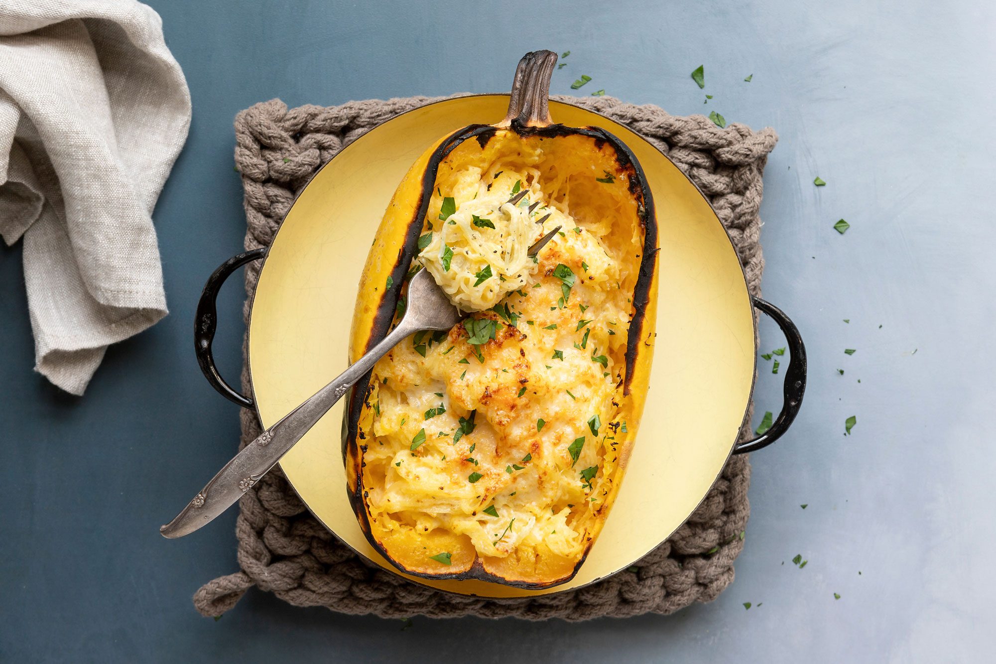Divide the squash noodles into and empty squash shell and add fresh chopped parsley to serve