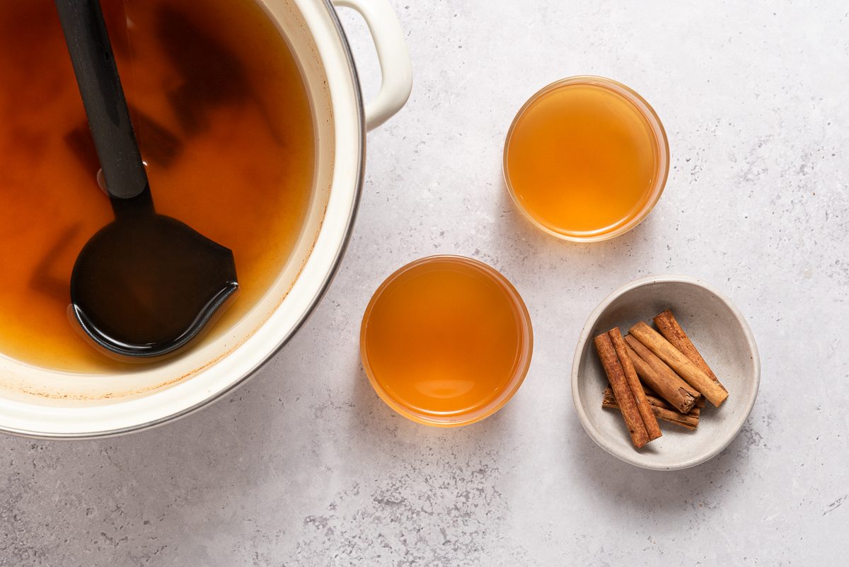 Apple Cider Inside Saucepan And Glasses