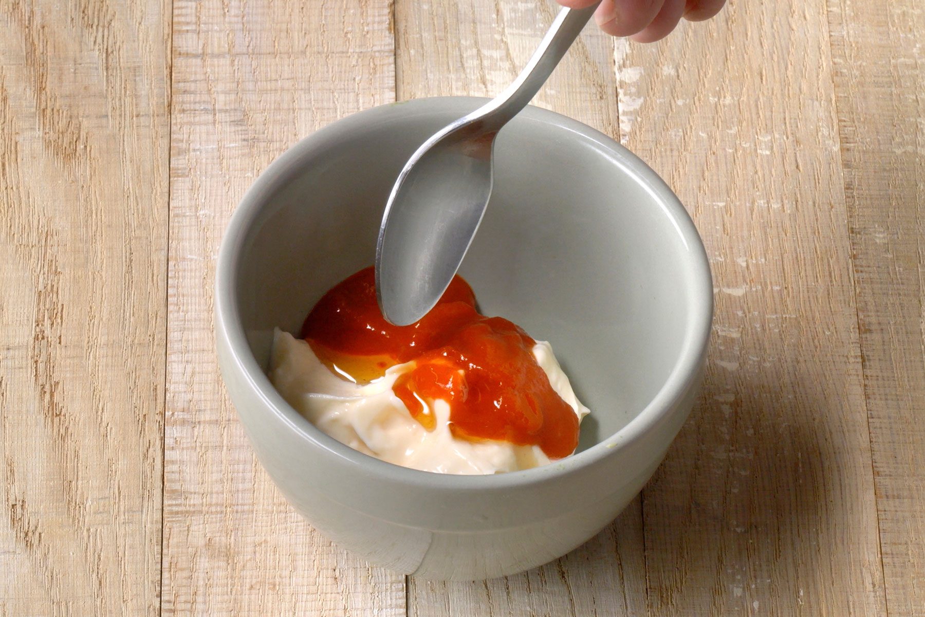 mayonnaise, Sriracha and sesame oil combined in a small bowl
