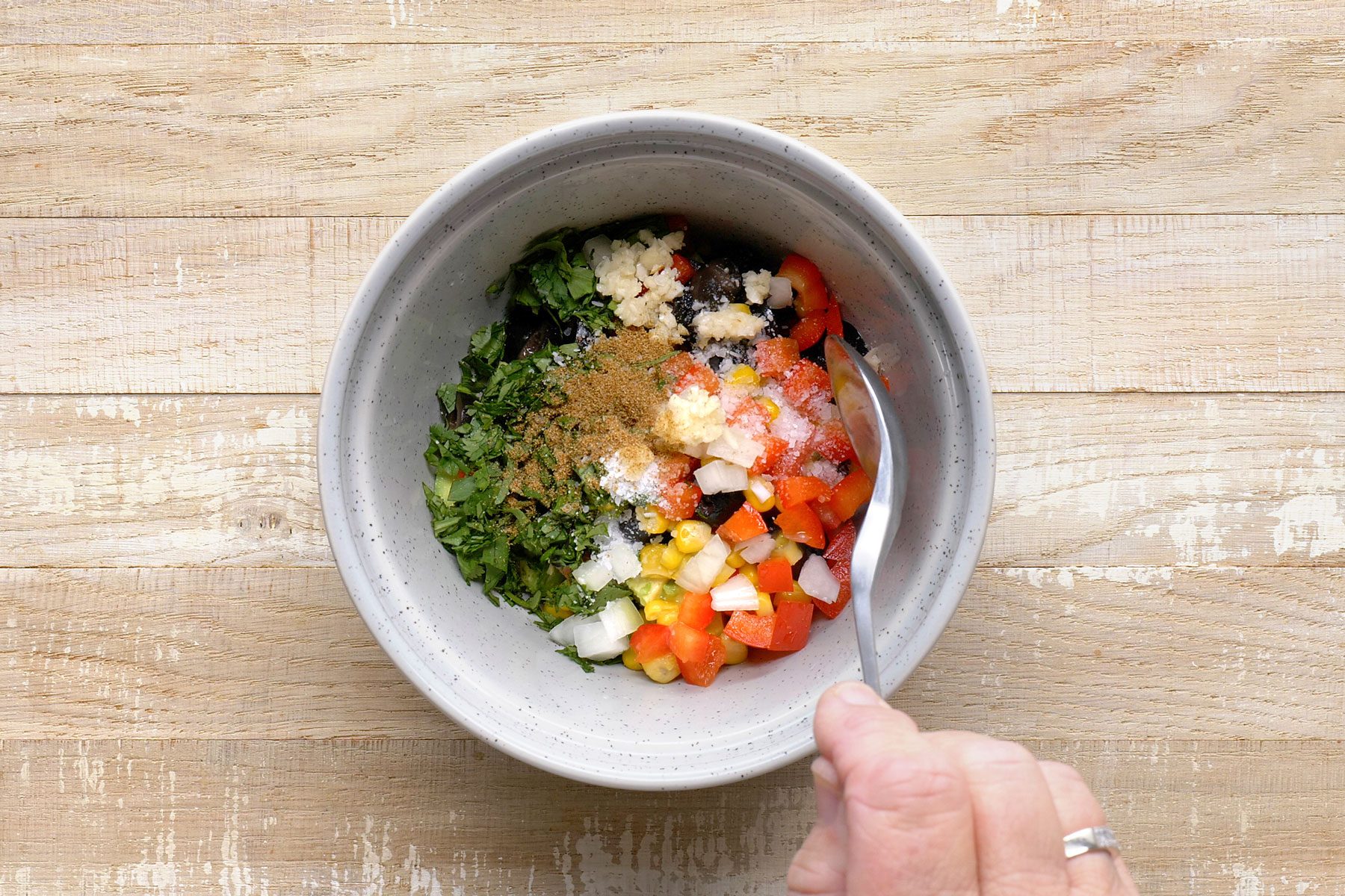 avocado, tomato, olives, corn, red pepper, lime juice, cilantro, salt, onion, garlic and cumin combined in a small bowl