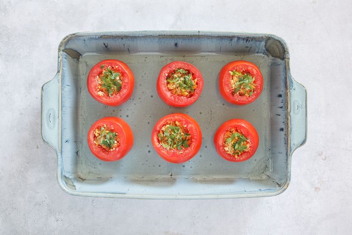Stuffing added to sliced tomatoes
