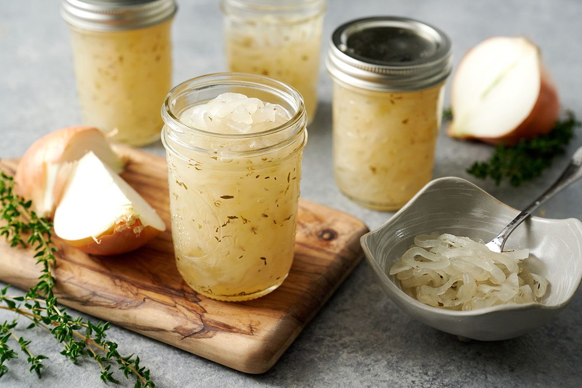 A hero shot of the finished Taste of Home Pickled Sweet Onions, showcasing the jars of bright, tangy pickled onions cooling on a countertop.