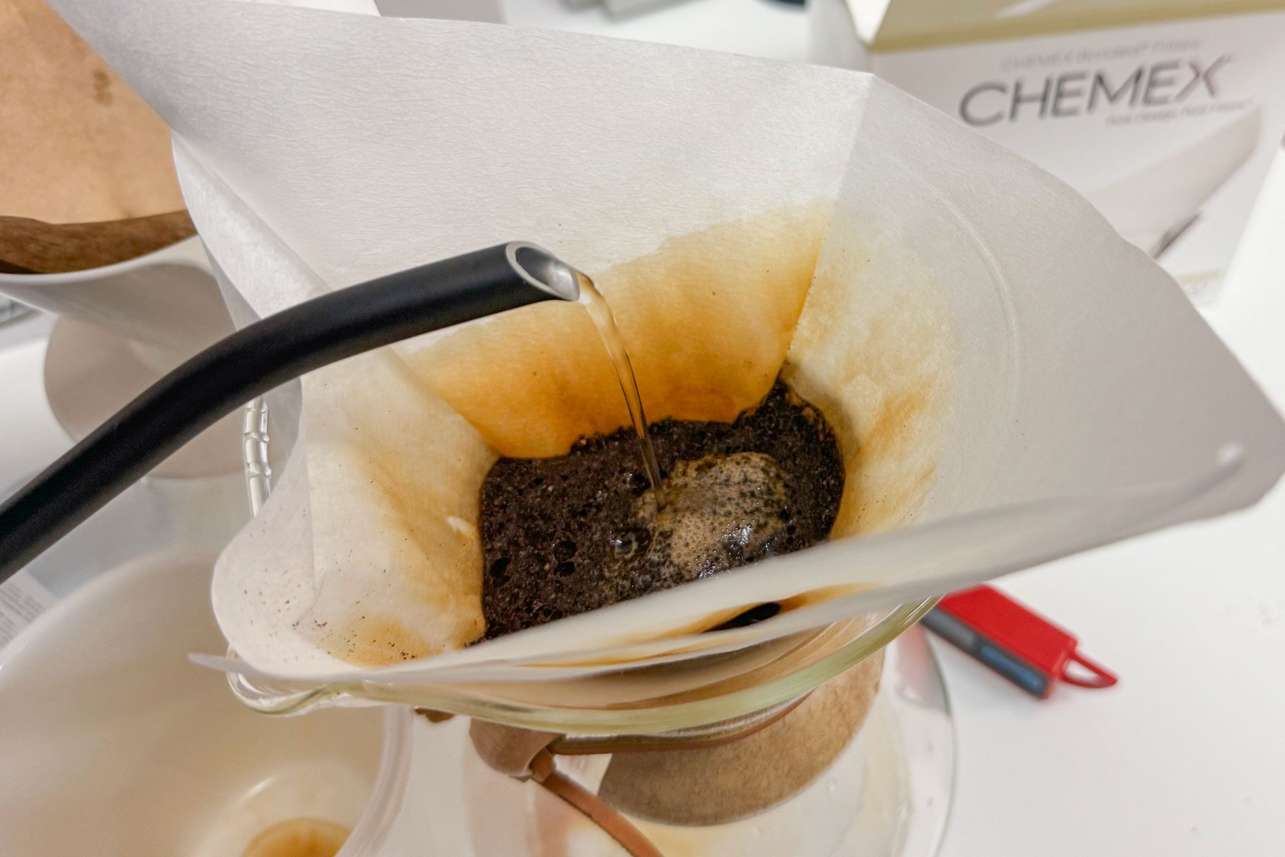 water being poured over coffee grounds
