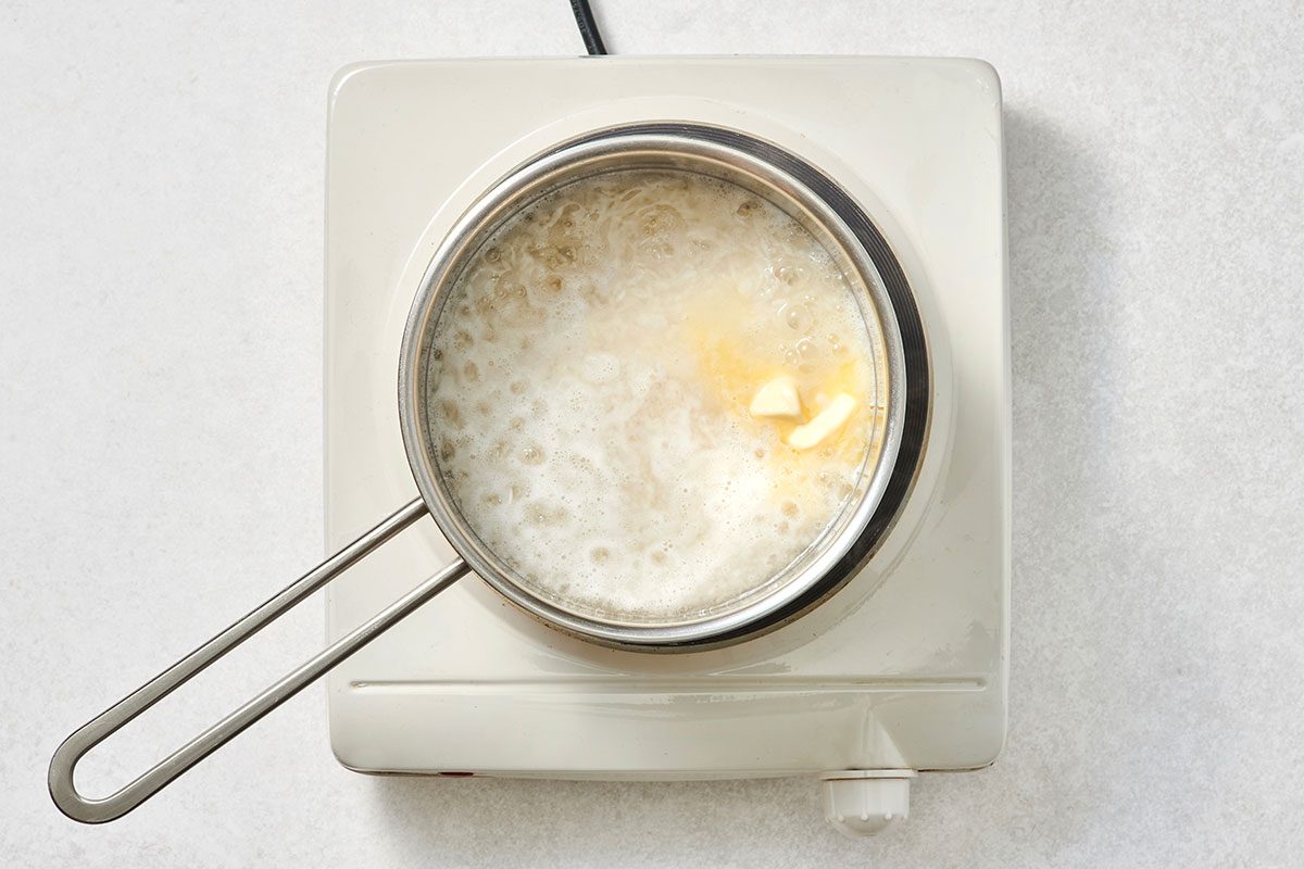 Rice simmering with butter in a small saucepan 