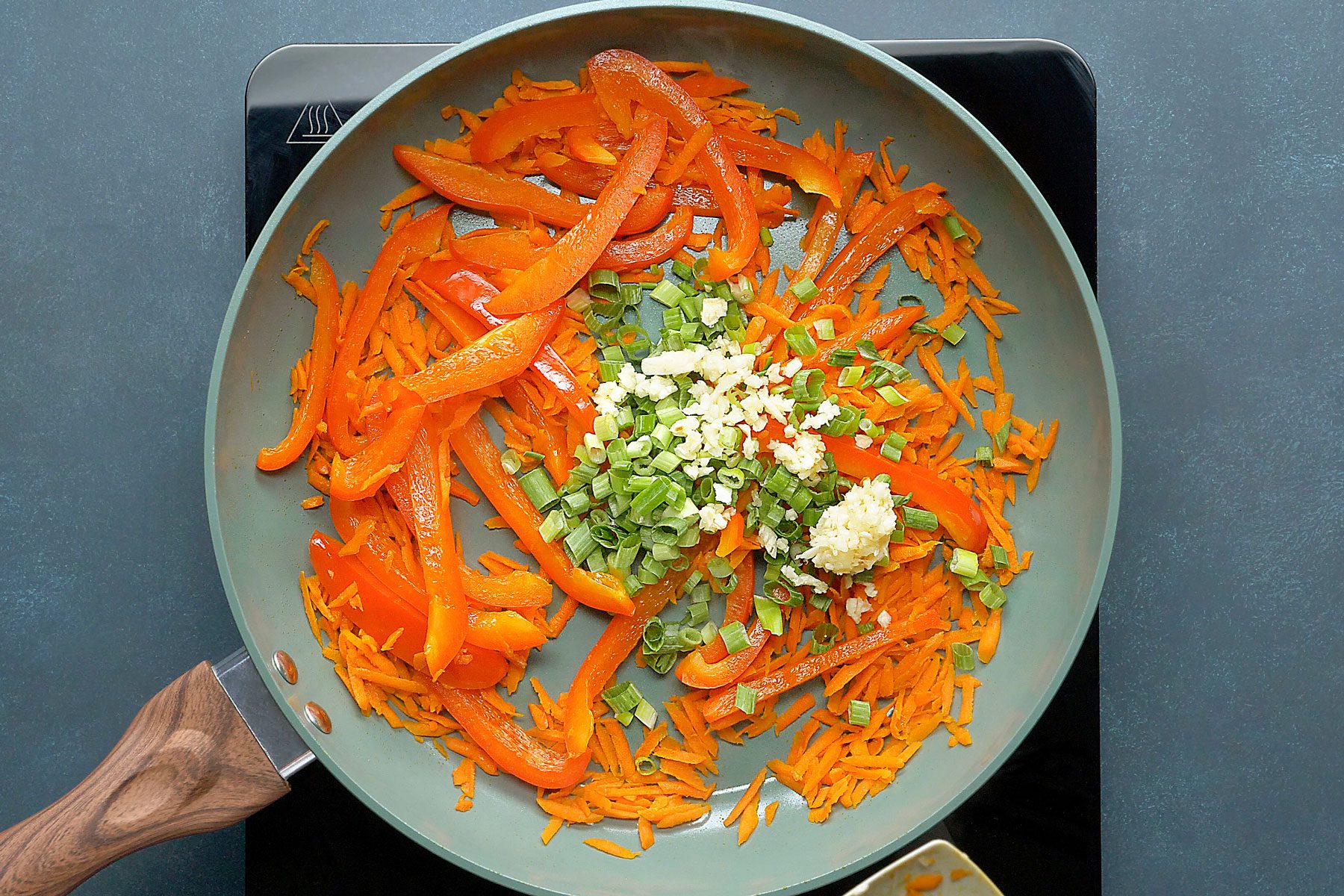 carrots and pepper being stir fried
