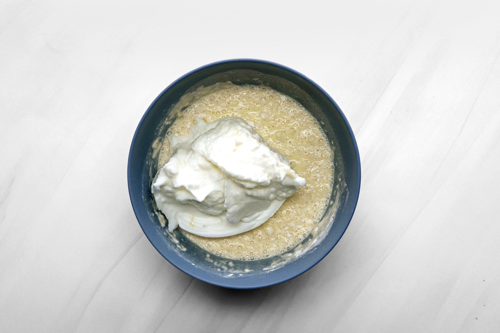 Gently fold the egg whites into the batter just until no white streaks remain