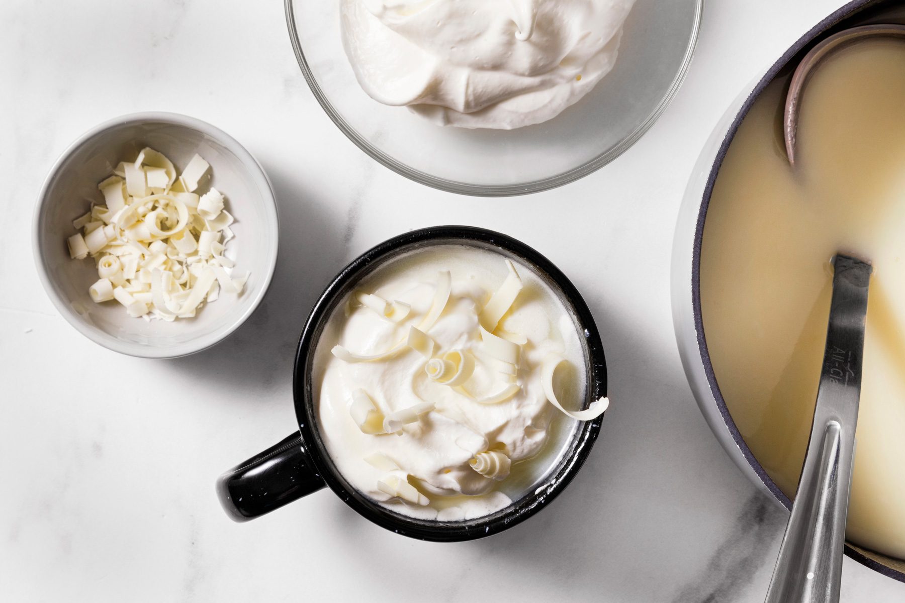 top with whipped cream and white chocolate curls.